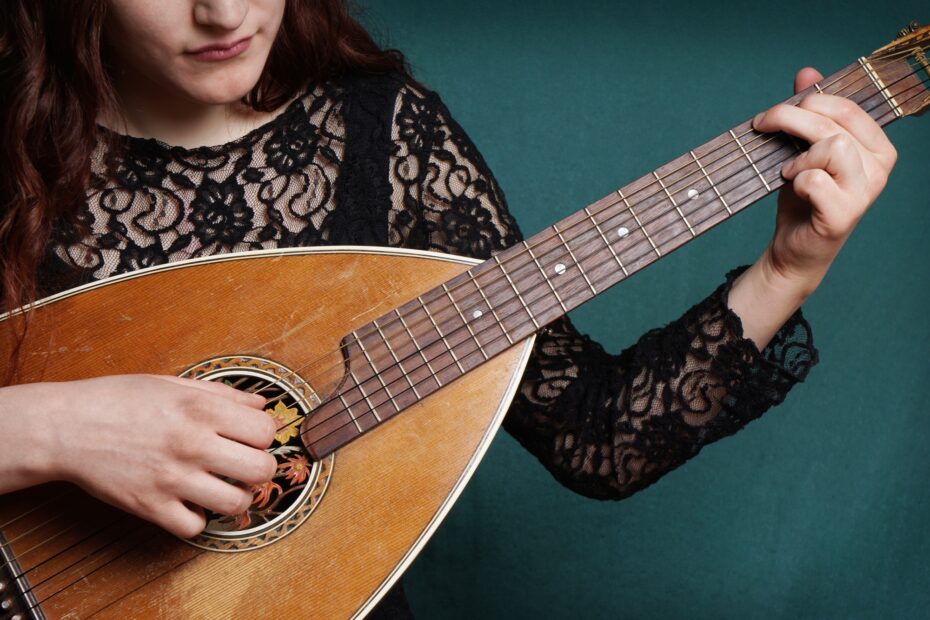 female playing lute string instrument