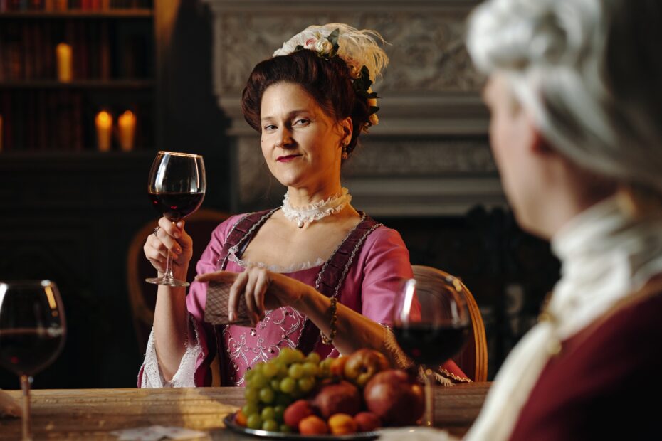 Portrait of Middle Aged Caucasian Woman Holding Playing Cards and Drinking Wine